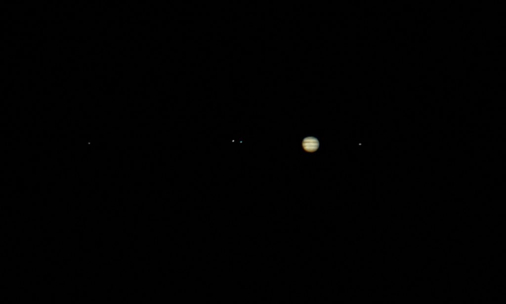 Jupiter and the 4 Galilean moons (2 of which are shown here), first discovered by Galileo, shine like stars in the darkness of night. The word "planet" actually means "wandering star."